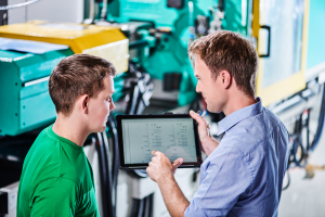 Ausbilder erklärt Lehrling Elektro-Schaltplan