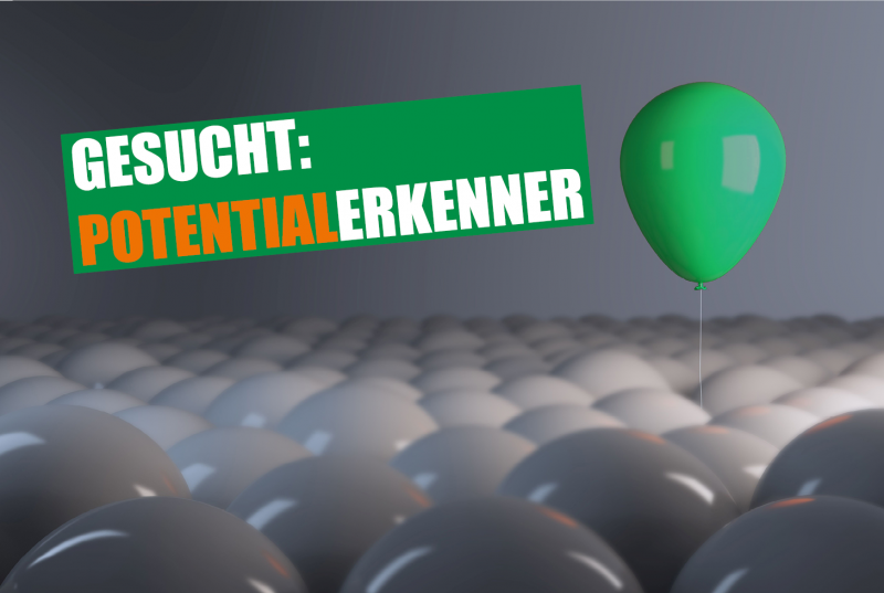 Grüner Luftballon hebt sich aus grauen ab